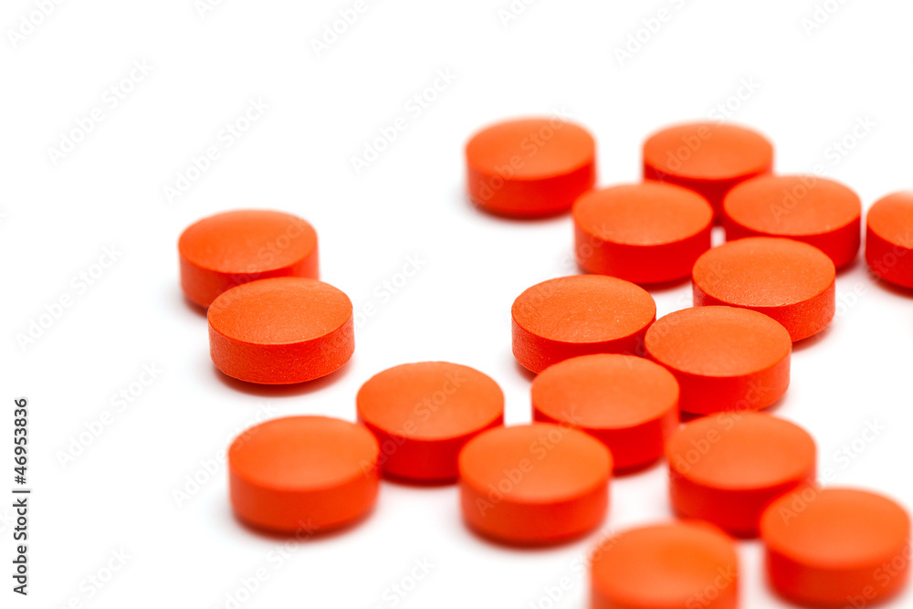 orange pills over white orange pills over white
