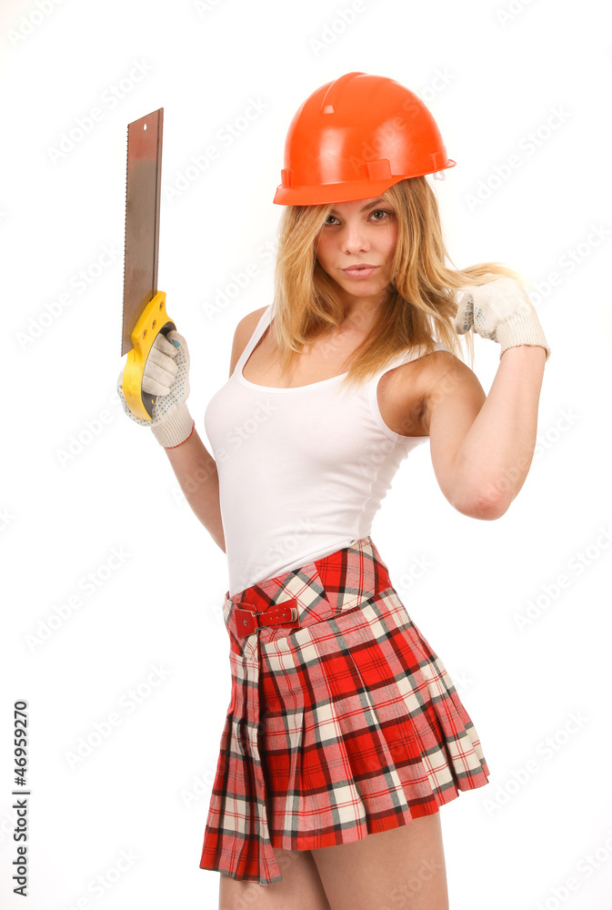 Beauty in the orange helmet and a saw on a white background. Beauty in the orange helmet and a saw on a white background.