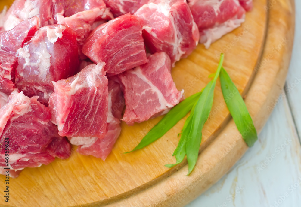 raw meat and knife on the wooden board