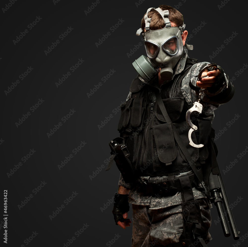 Soldier With  A Gas Mask Holding Handcuffs