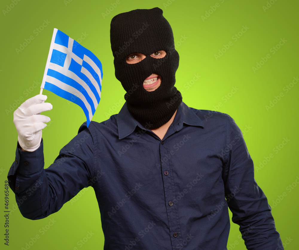 Man wearing robber mask and holding flag Man wearing robber mask and holding flag