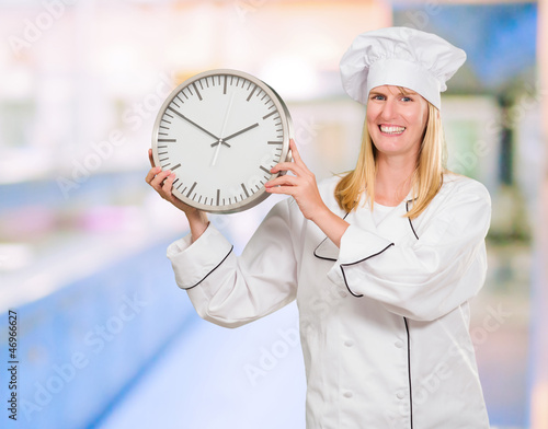 Female Chef Holding Clock