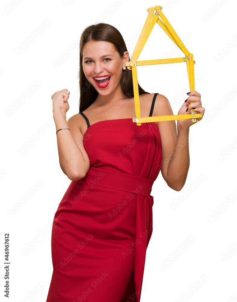 Woman Holding House Frame doing a success gesture