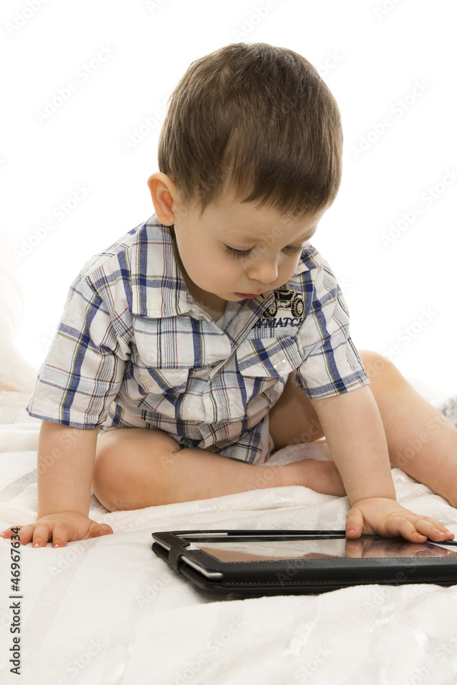 Little boy using electronic tab Little boy using electronic tab