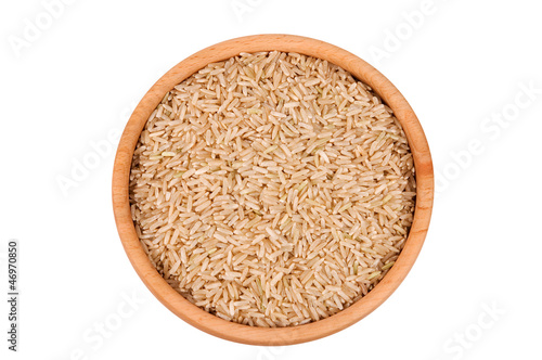Raw brown rice in wooden bowl isolated on white (clipping path)