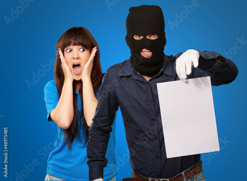 Burglar Man Holding Paper In Front Scared Woman