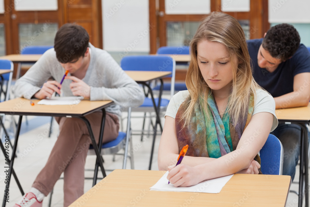Female student sitting at table Female student sitting at table