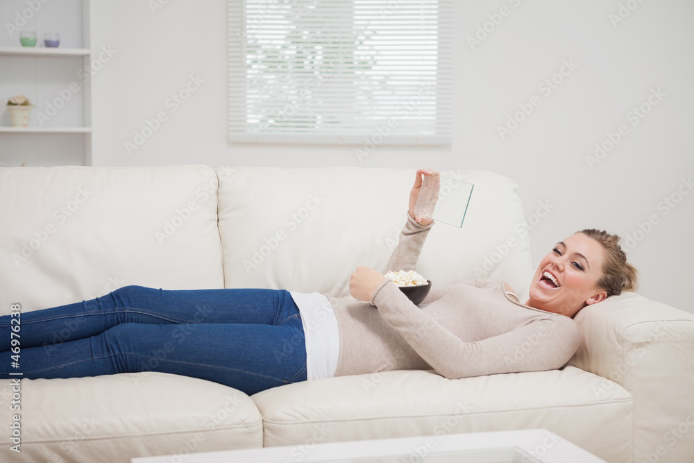 Woman laughing at the clear pane while lying down Woman laughing at the clear pane while lying down