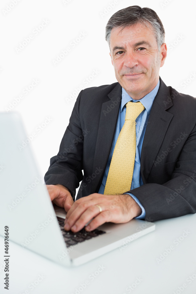 Happy man typing on his laptop Happy man typing on his laptop