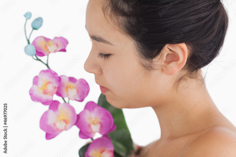 Woman smelling on orchids Woman smelling on orchids