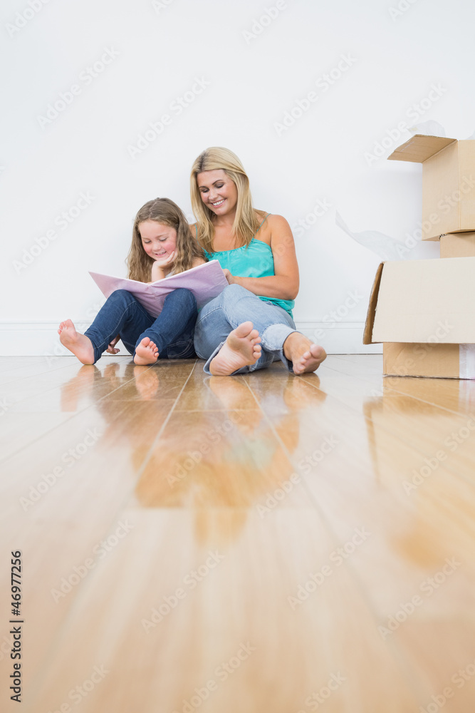 Pretty mother and daughter reading a book Pretty mother and daughter reading a book