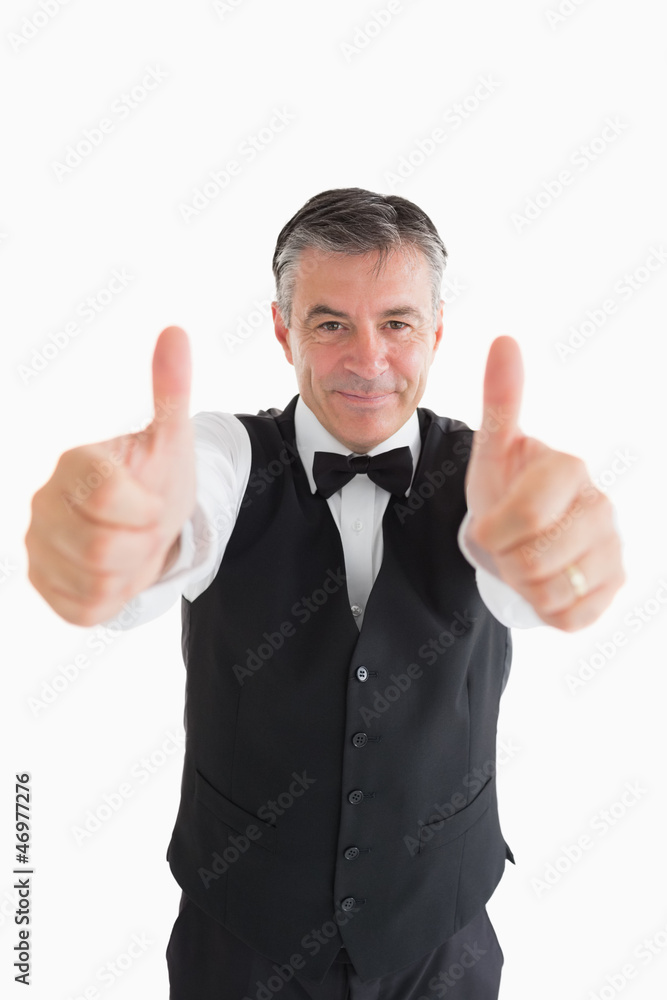 Well-dressed waiter having thumbs up Well-dressed waiter having thumbs up