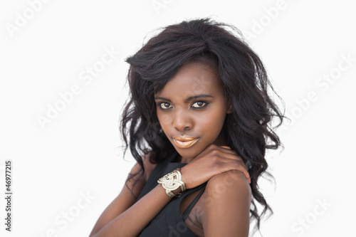 Woman in black dress and gold lips