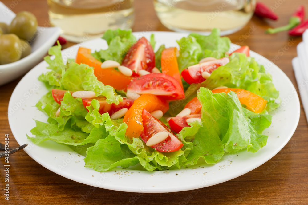 vegetables salad with pine nuts on the plate vegetables salad with pine nuts on the plate