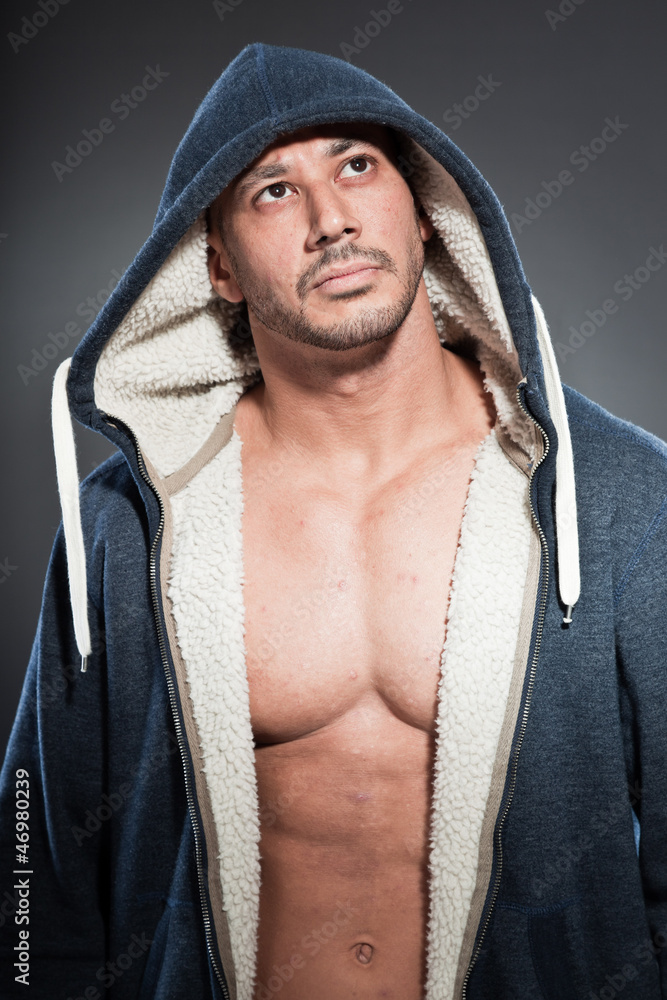 Muscled fitness man. Cool looking. Wearing blue hoody shirt. Muscled fitness man. Cool looking. Wearing blue hoody shirt.