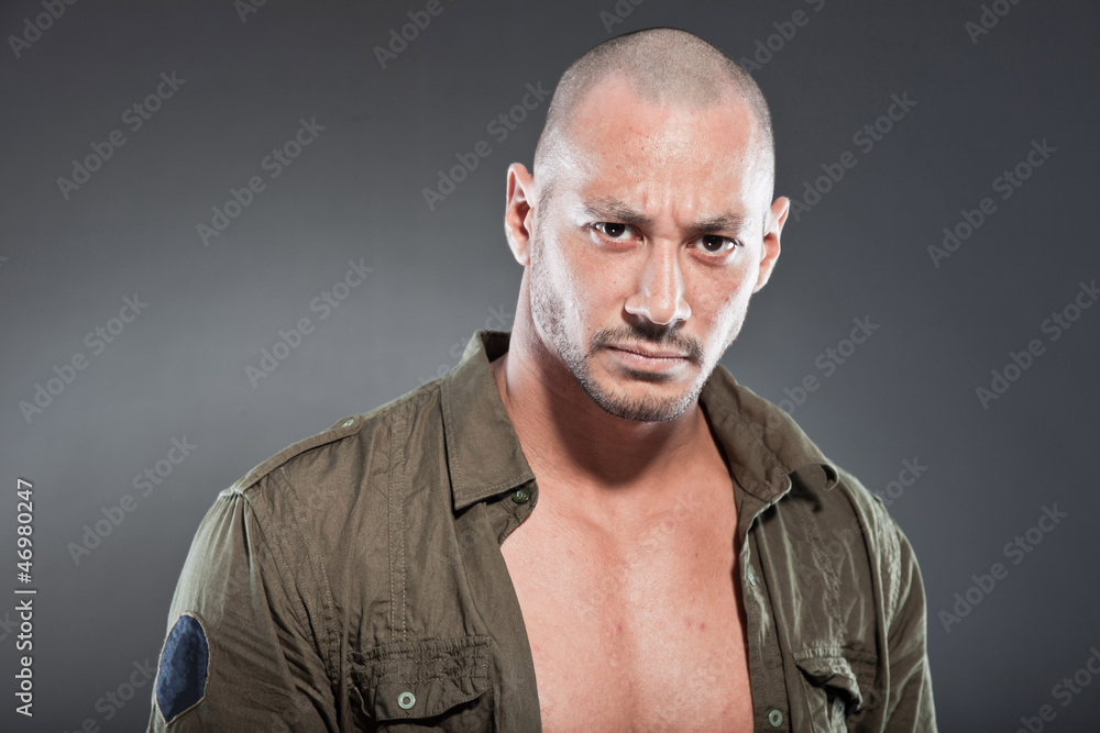 Muscled tough guy wearing green army shirt. Good looking man. Muscled tough guy wearing green army shirt. Good looking man.