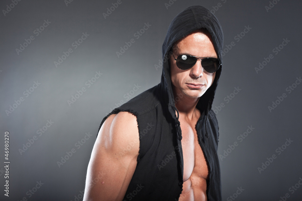 Muscled fitness man. Cool looking. Tough guy with black shirt. Muscled fitness man. Cool looking. Tough guy with black shirt.