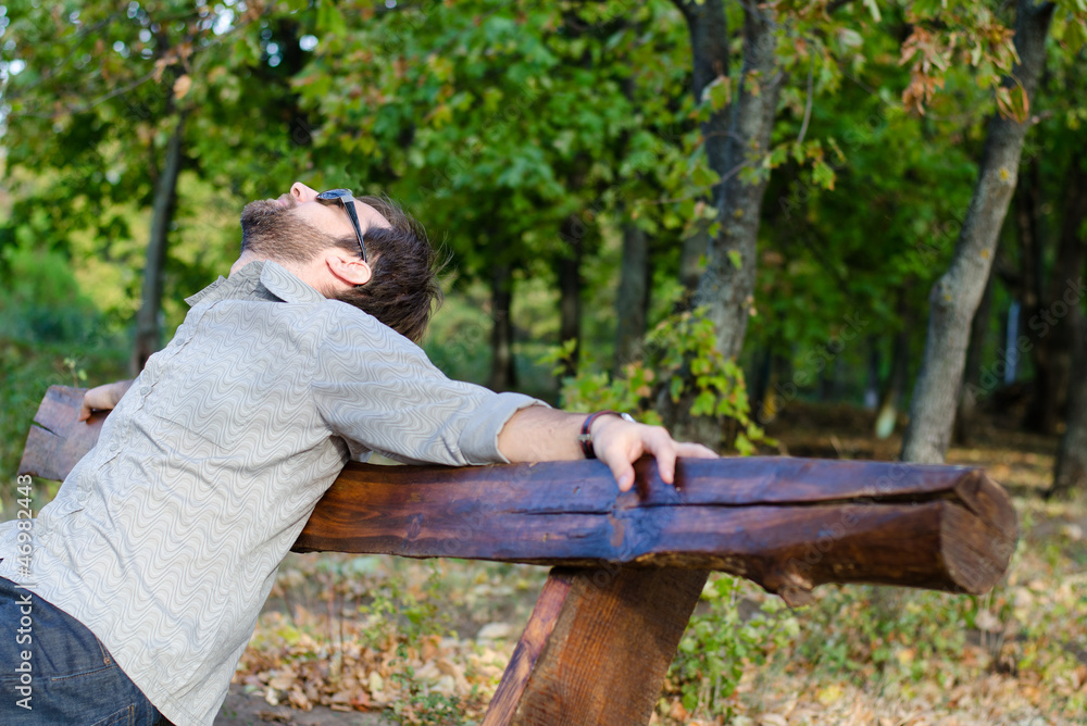 Fototapeta premium Man relaxing on bench