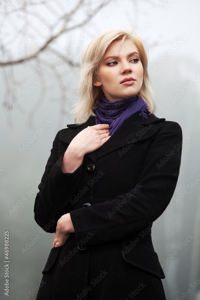 Young woman walking in an autumn foggy field Young woman walking in an autumn foggy field