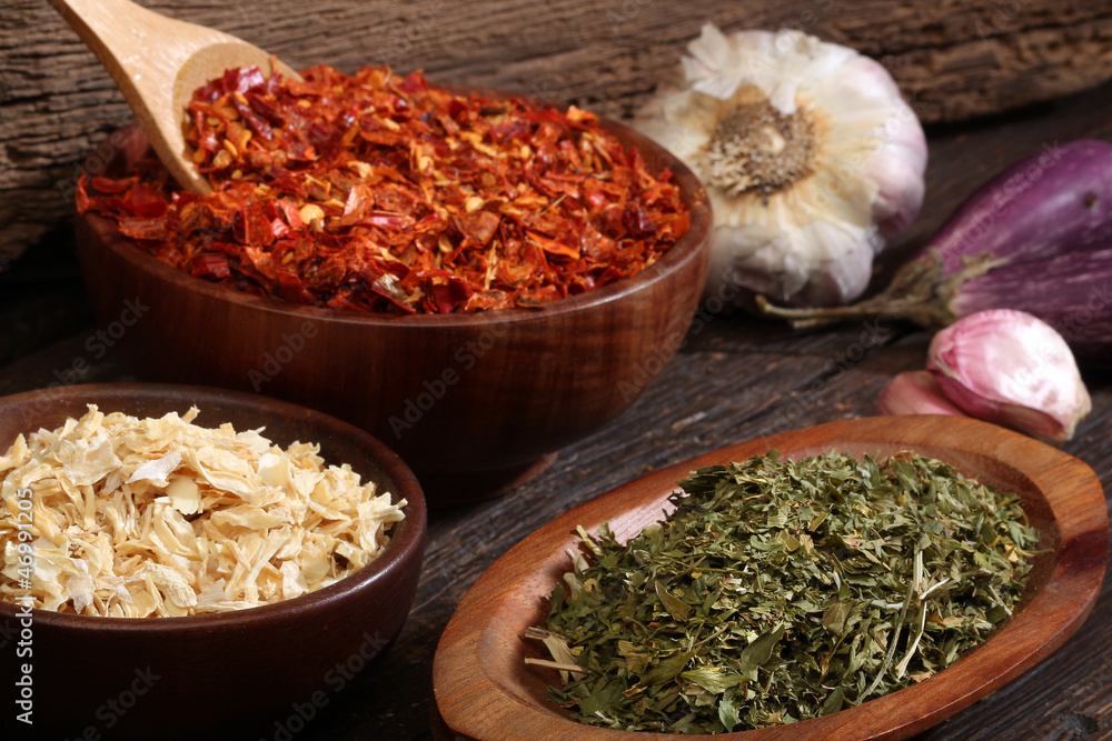 Various spices over a wood background. Various spices over a wood background.