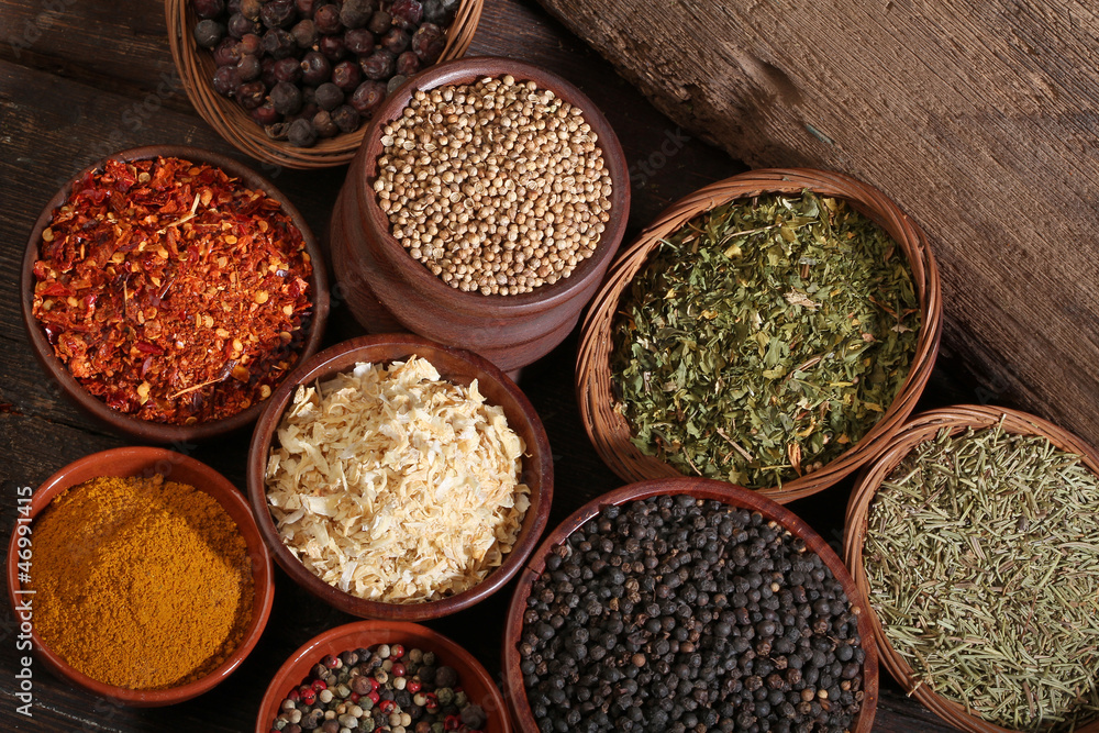 Different bowls of spices over a wooden background Different bowls of spices over a wooden background