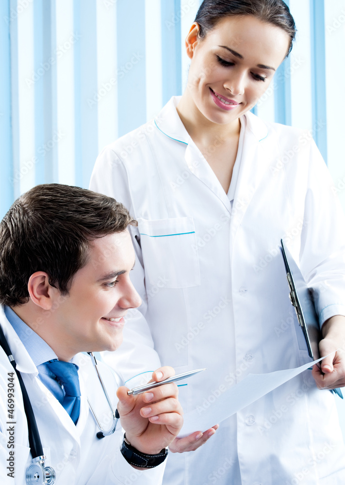 Two happy medical people working at office Two happy medical people working at office