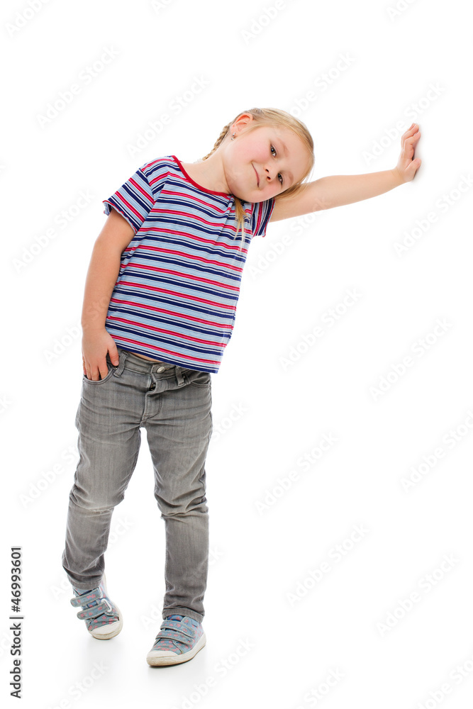Little girl leaning against a white wall. Little girl leaning against a white wall.