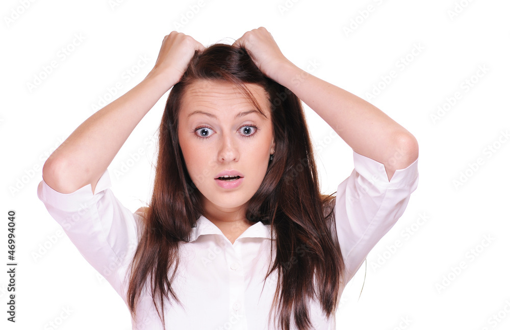 A shocked woman with her hands in her hair A shocked woman with her hands in her hair