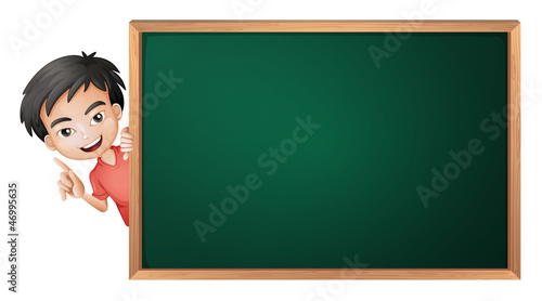 a boy and a green board
