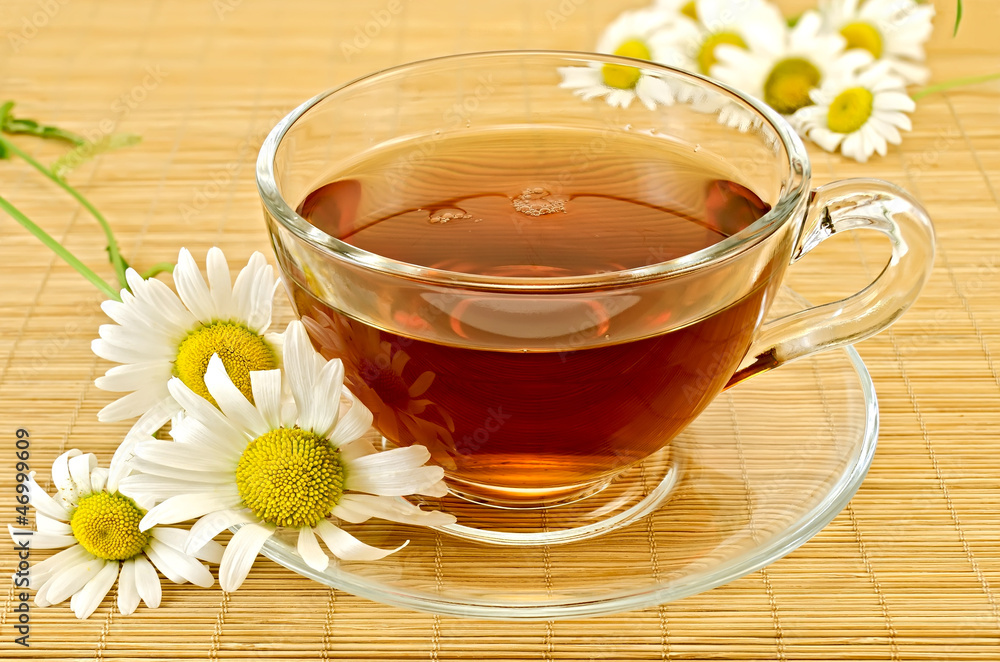Herbal tea with camomiles on a bamboo Herbal tea with camomiles on a bamboo