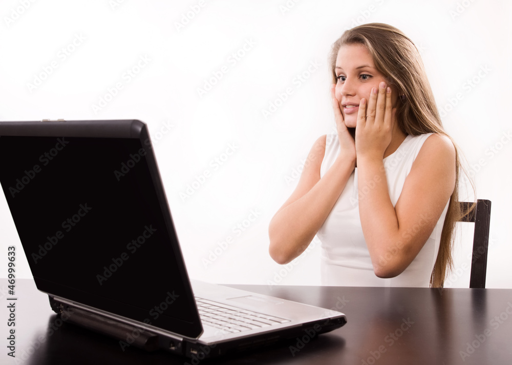 Astonished girl behind a laptop Astonished girl behind a laptop