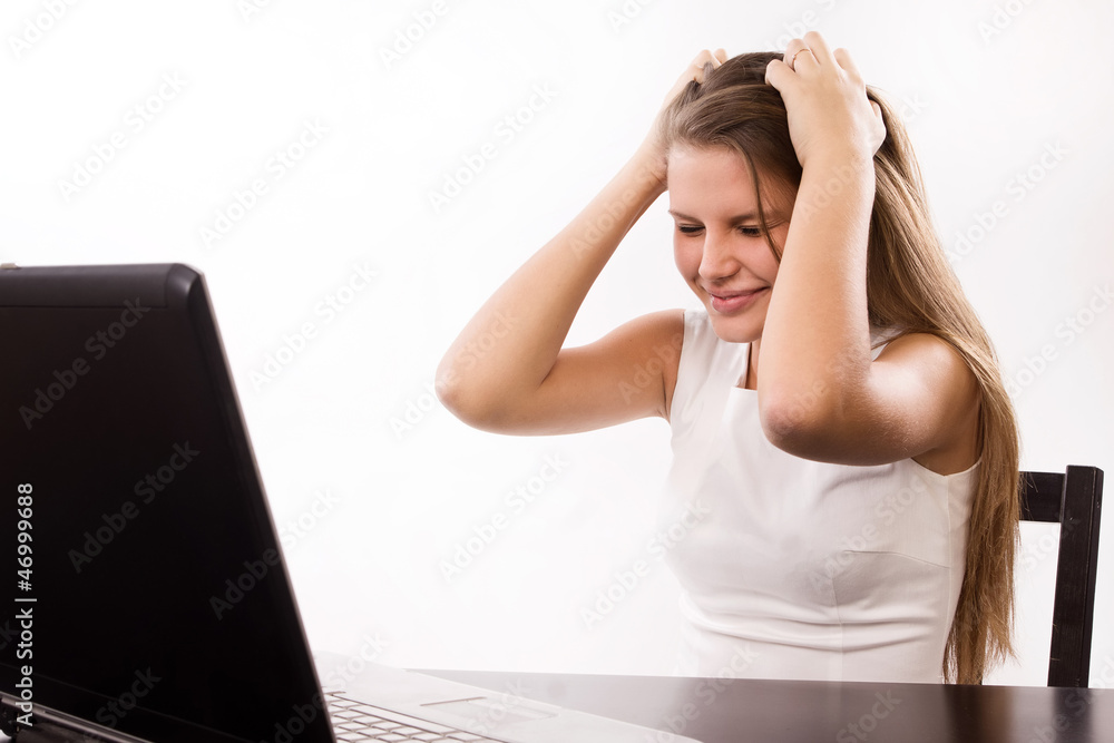 Distraught girl behind a laptop Distraught girl behind a laptop