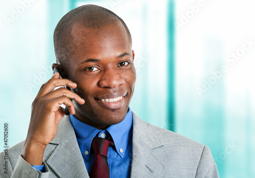 African businessman at phone in his office