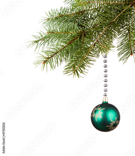 Green bauble on green christmas firtree on white background 