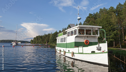 Photography Small white pleasure boat moored on Saimaa lake in Finland