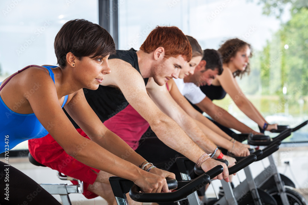 Group of People Cycling at Gym