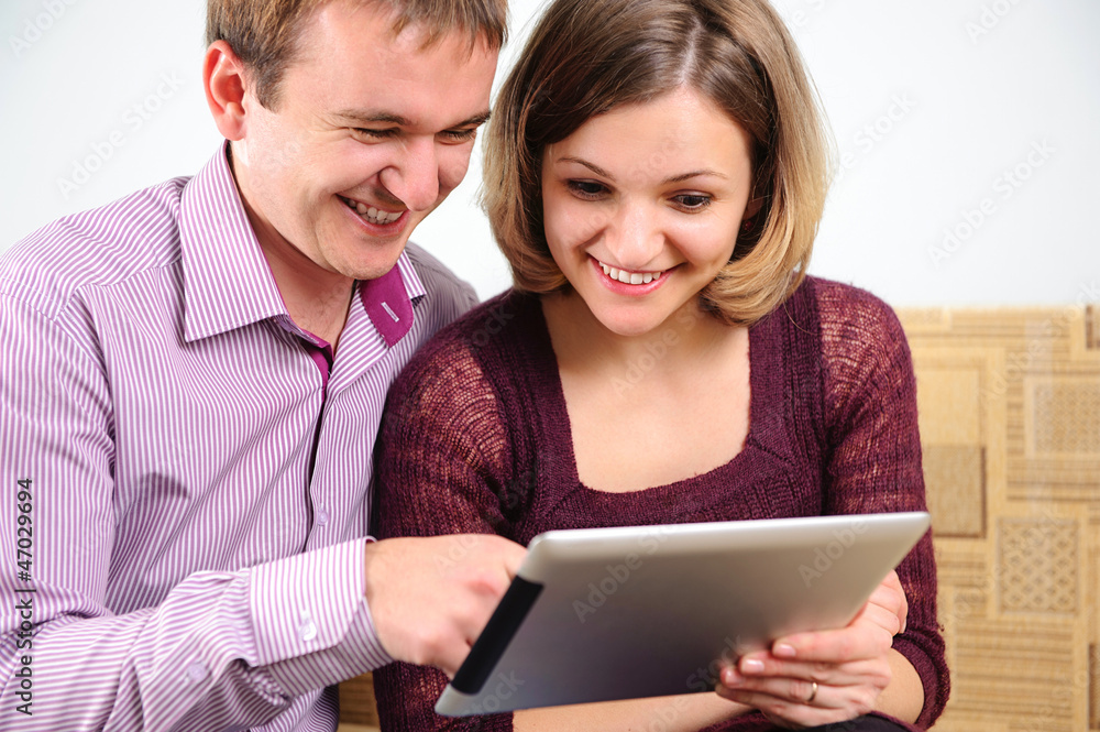 Young smiling couple with digital tablet Young smiling couple with digital tablet