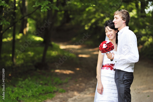 Portrait of happy bride and groom in a park