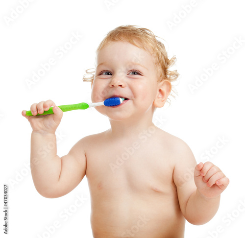 Smiling kid brushing teeth