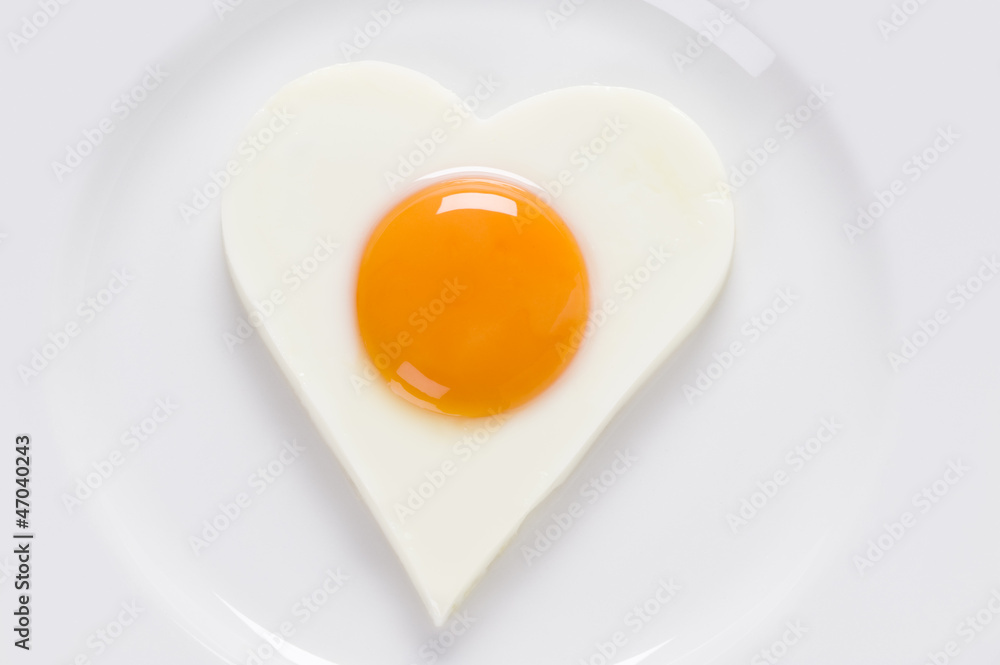 heart shaped cooked egg on a plate heart shaped cooked egg on a plate