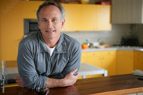 Man leaning on kitchen surface