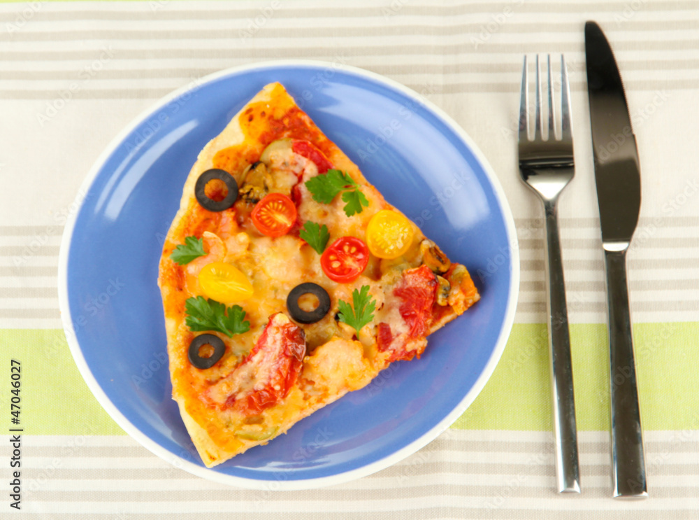 plate with a slice of delicious pizza on tablecloth close-up plate with a slice of delicious pizza on tablecloth close-up
