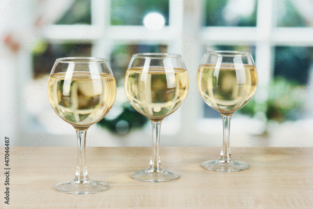 White wine in glass on window background White wine in glass on window background