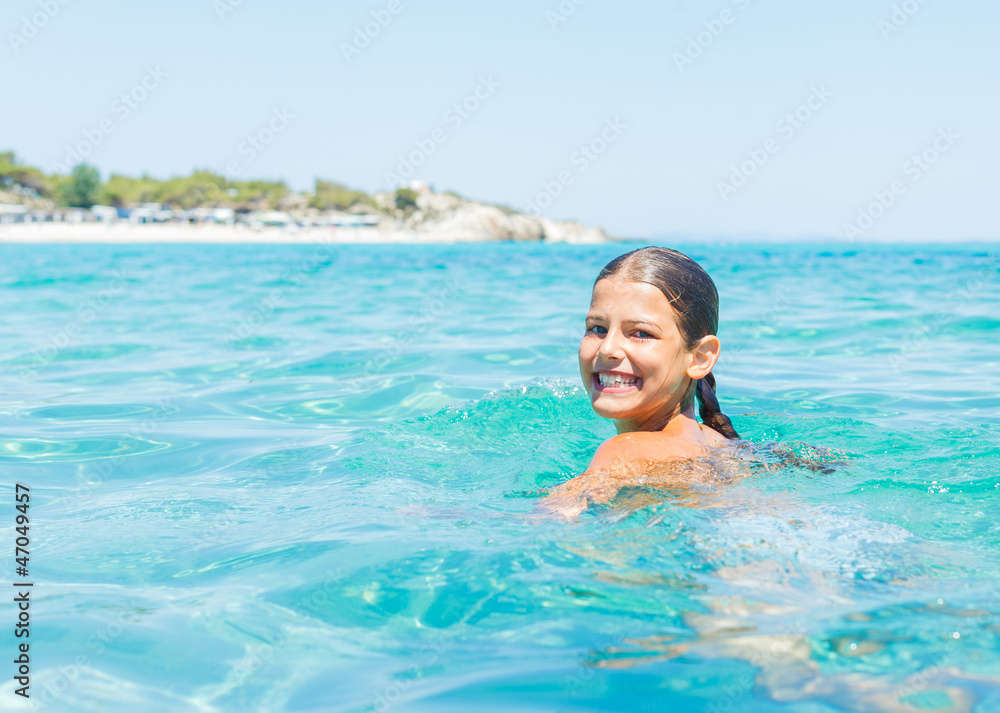 Young girl playing in the sea