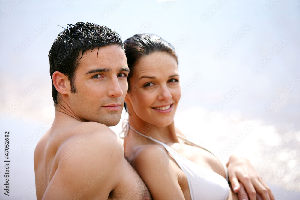 Couple in swimsuit at the oceanside Couple in swimsuit at the oceanside