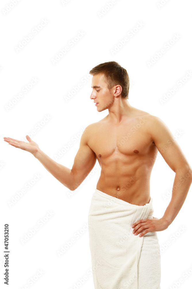 A nude young man covering himself with a towel