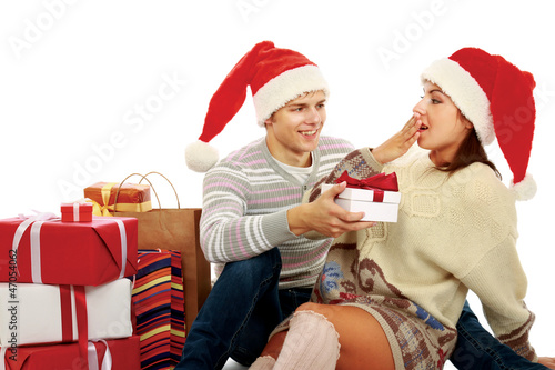 Portrait of young pretty couple holding christmas