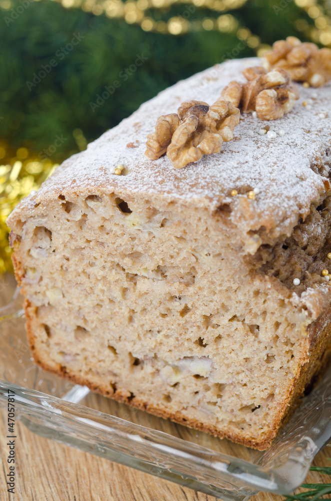 Christmas sliced banana cake with walnuts and dusted with icing Christmas sliced banana cake with walnuts and dusted with icing