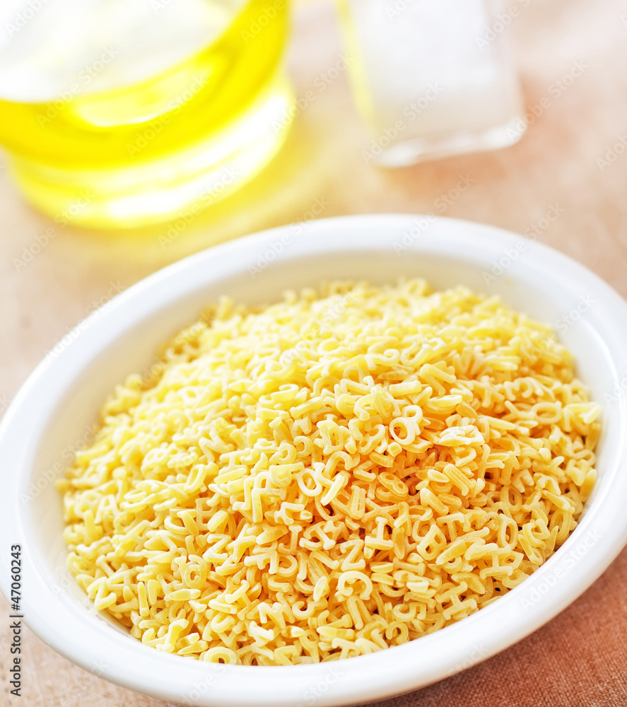 assortment of raw pasta and wheat on wooden background assortment of raw pasta and wheat on wooden background