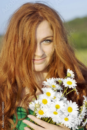 red-haired girl is walking in the spring